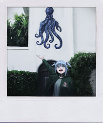  absurdres alternate_costume blue_eyes blue_hair blush bush commentary faux_photograph female gawr_gura green_jacket highres hololive hololive_english jacket letterman_jacket looking_at_viewer octopus open_hand open_mouth polaroid sharp_teeth solo teeth tree vincent_wu virtual_youtuber 